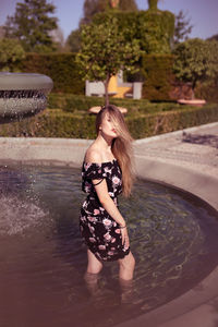 Full length of girl standing in water