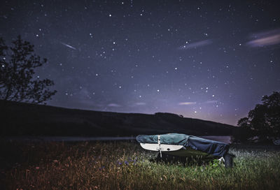 Tent on field against sky at night