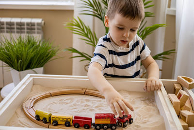 Portrait of cute boy playing on table