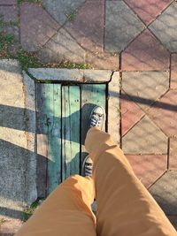 Low section of man standing on footpath