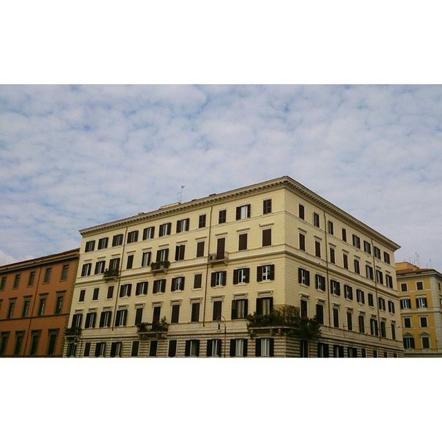 architecture, building exterior, built structure, transfer print, sky, city, window, auto post production filter, low angle view, building, cloud - sky, residential building, cloud, residential structure, facade, day, city life, outdoors, cloudy, no people