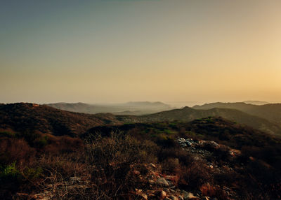 Scenic view of mountains against clear sky during sunset