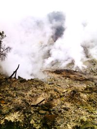 Scenic view of mountain against cloudy sky