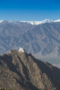 Scenic view of snowcapped mountains against clear sky