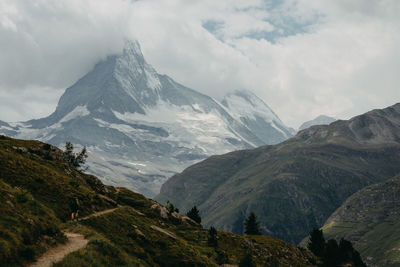 Scenic view of mountains against cloudy sky