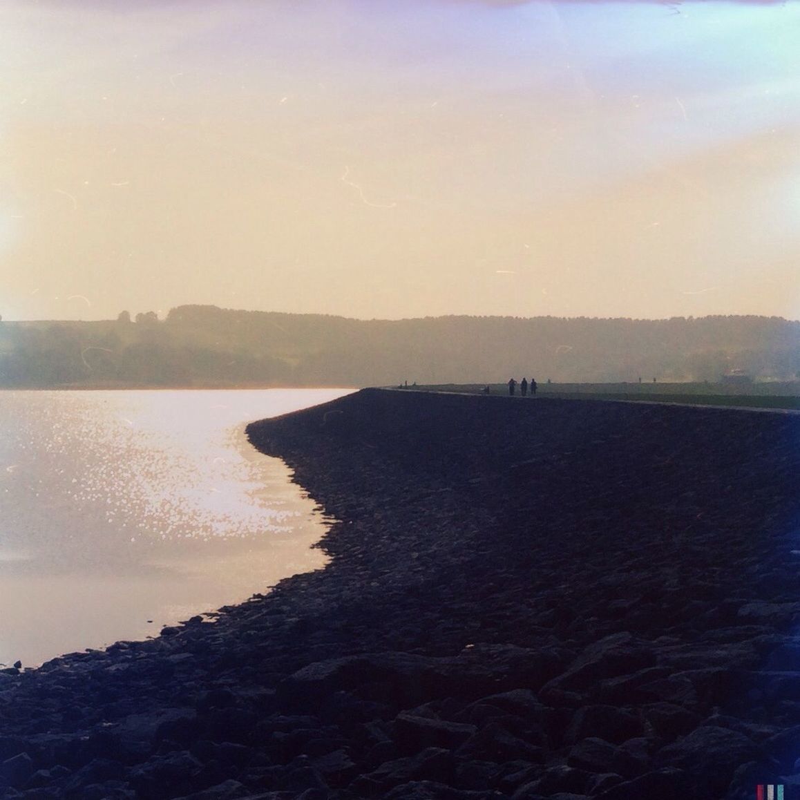 water, sea, tranquility, sky, silhouette, tranquil scene, sunset, nature, sunlight, beach, beauty in nature, scenics, no people, outdoors, day, clear sky, built structure, horizon over water, idyllic, copy space