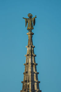 Top of the town hall tower in munich with a figure on it