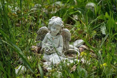 Statue of angel on field