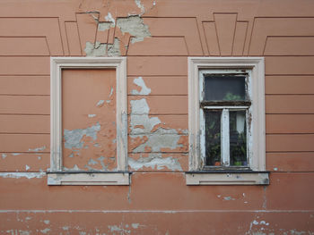 Window and empty space for other on the damaged wall 