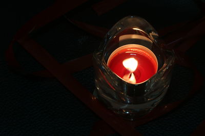 High angle view of illuminated tea light candles on table