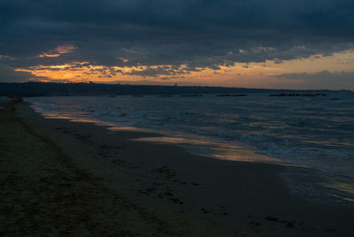 Scenic view of beach against sky during sunset