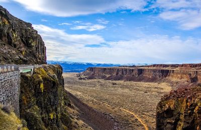 Scenic view of valley and mountain against sky 