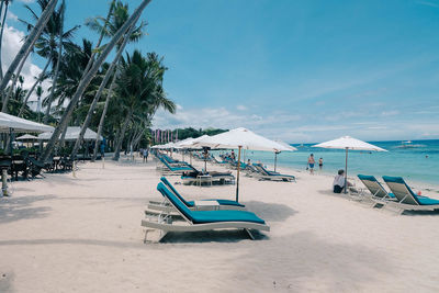 Scenic view of beach against blue sky