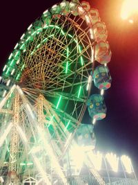 Low angle view of illuminated ferris wheel