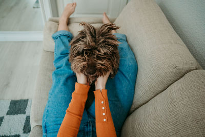 Low section of woman playing with dog