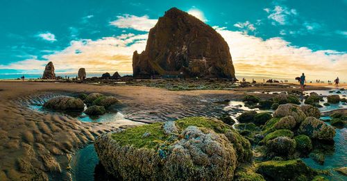 Panoramic view of rocks on beach against sky