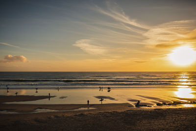 Scenic view of beach against sky during sunset