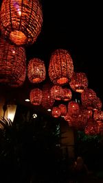 Low angle view of illuminated christmas tree at night