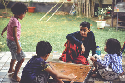 Rear view of people sitting in traditional clothing