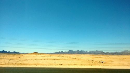 Scenic view of landscape against blue sky