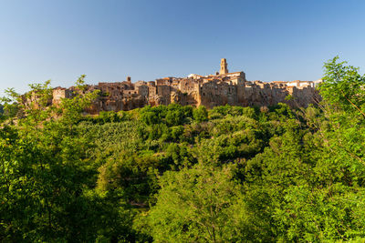 Little beautiful medieval town pitigliano in tuscany, italy against blue sky