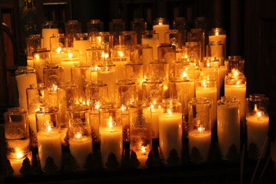 Close-up of lit candles in temple