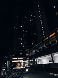 Low angle view of illuminated buildings in city at night