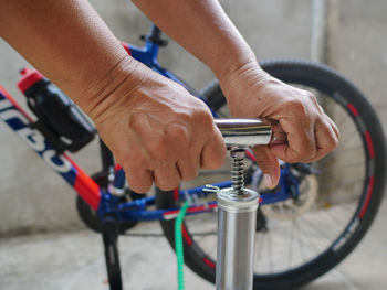 Close-up of man holding bicycle