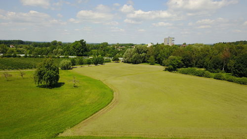 Scenic view of green landscape against sky