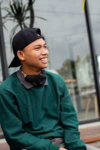 Portrait of a smiling young man looking away