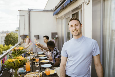 Portrait of young man standing in restaurant