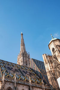 Low angle view of a cathedral building against blue sky in vienna 