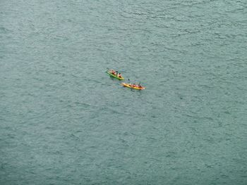 High angle view of people floating on sea