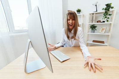 Portrait of young woman using digital tablet on table