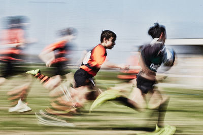 Group of people running against blurred background