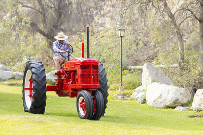 Man driving tractor outdoors