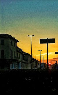 Silhouette of building against sky at sunset