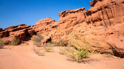 Rock formations on mountain against clear sky