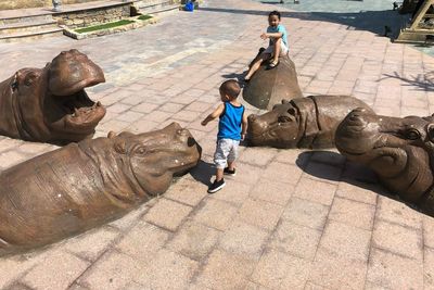 High angle view of men statue on footpath