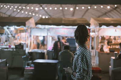 Series photo of young woman tourist wear surgical medical mask touring in street night market
