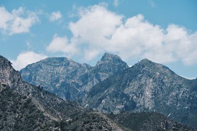 Scenic view of mountains against cloudy sky