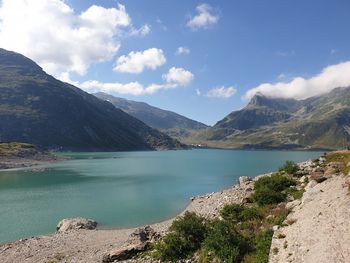 Scenic view of lake and mountains against sky