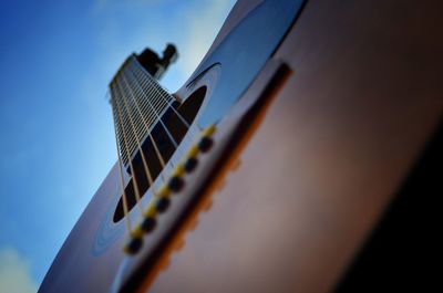 Close-up of guitar against sky