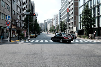 Vehicles on road along buildings