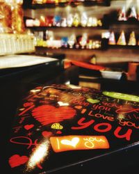 Close-up of illuminated text on table at store