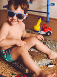 High angle view of baby boy sitting on toy