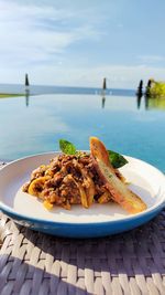 Close-up of food in plate on table against sky