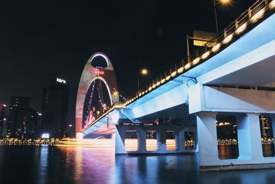 Low angle view of bridge lit up at night