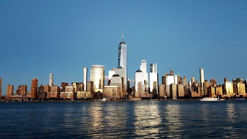 Modern buildings in city against clear sky