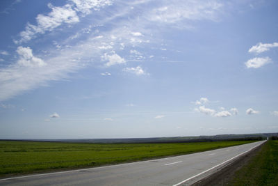 Road by landscape against sky